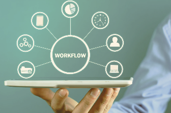 Person holding a digital tablet displaying a virtual workflow diagram with icons for team, tools, and tasks, symbolizing proactive business systems.