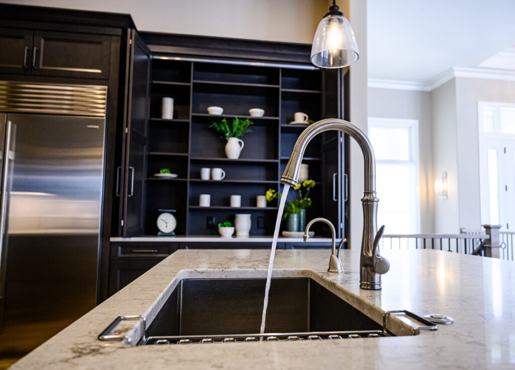 kitchen faucet running water in newly remodeled kitchen